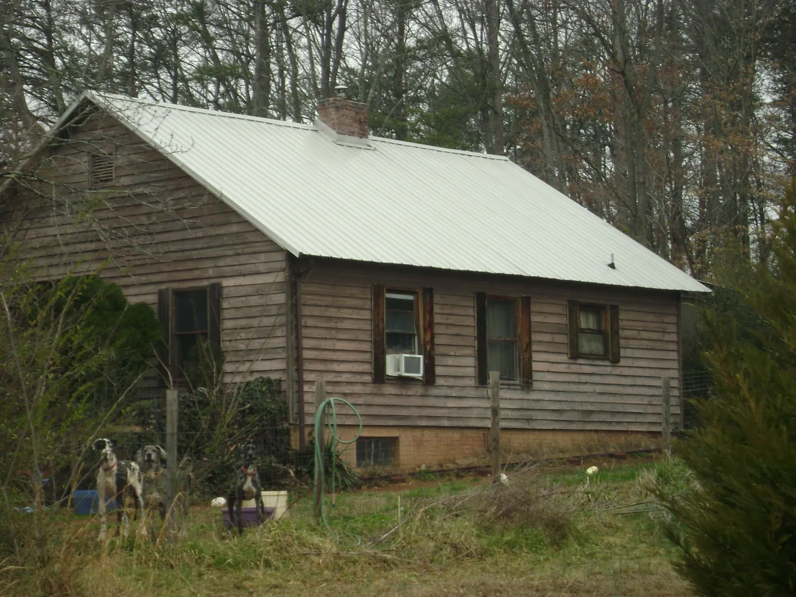 White metal roof on an old wood sided farmhouse, from a Metal Roof Installation job in Lynchburg